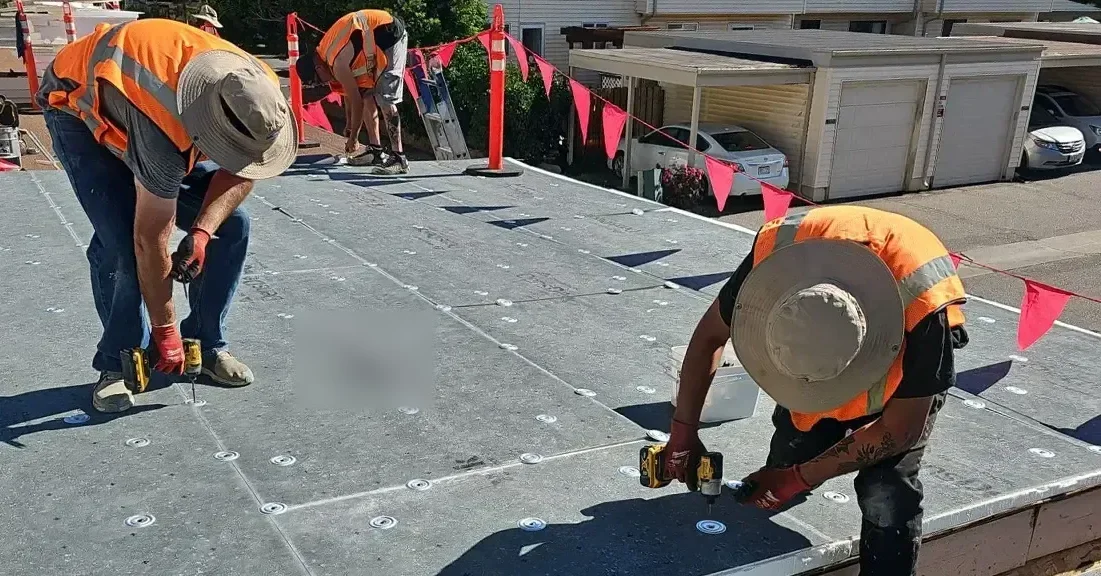 Roofing crew at work on a commercial roof